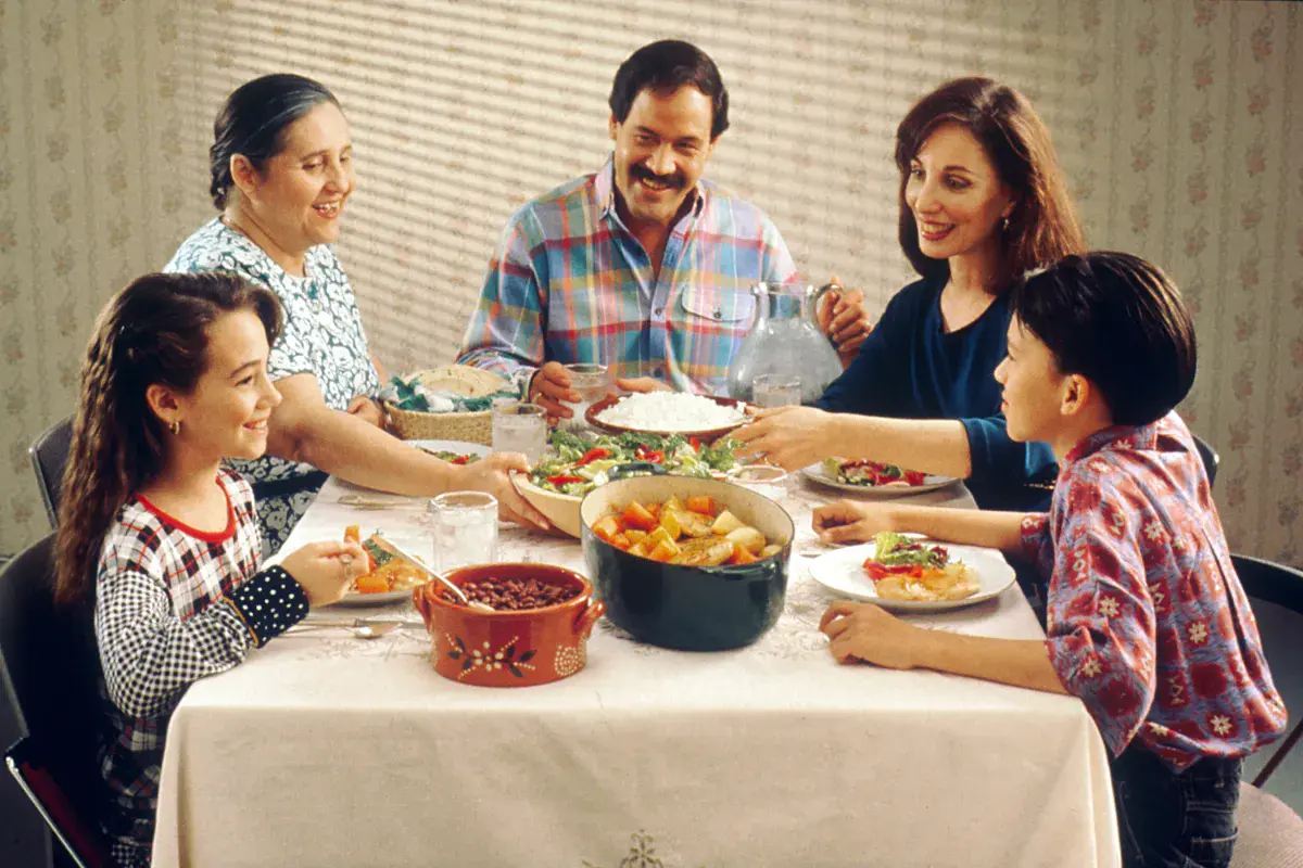 American family gathered around the dinner table where regional food words like catsup become