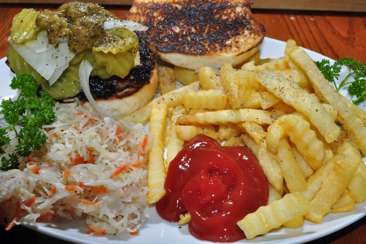 A classic burger and fries with ketchup on the side