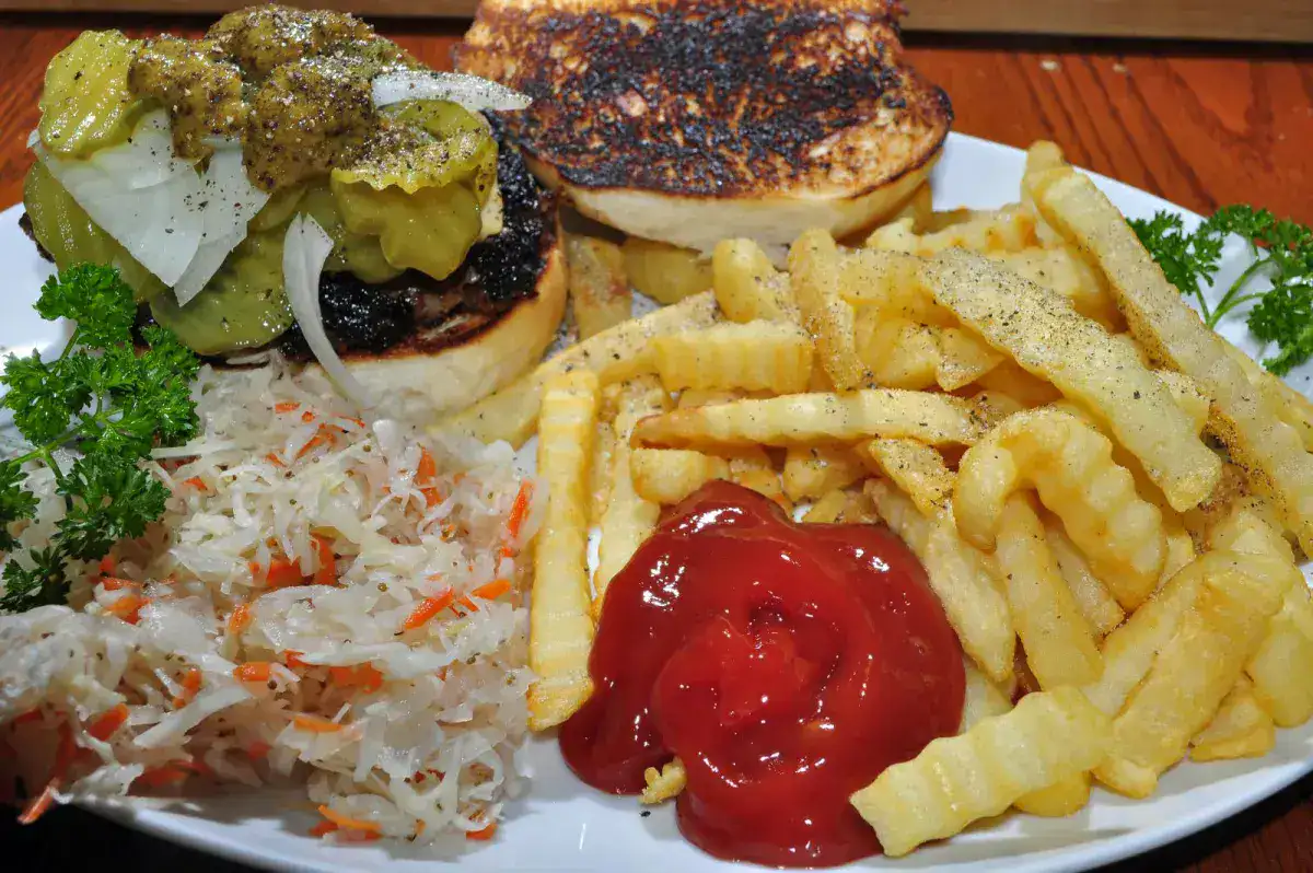A classic burger and fries with ketchup on the side