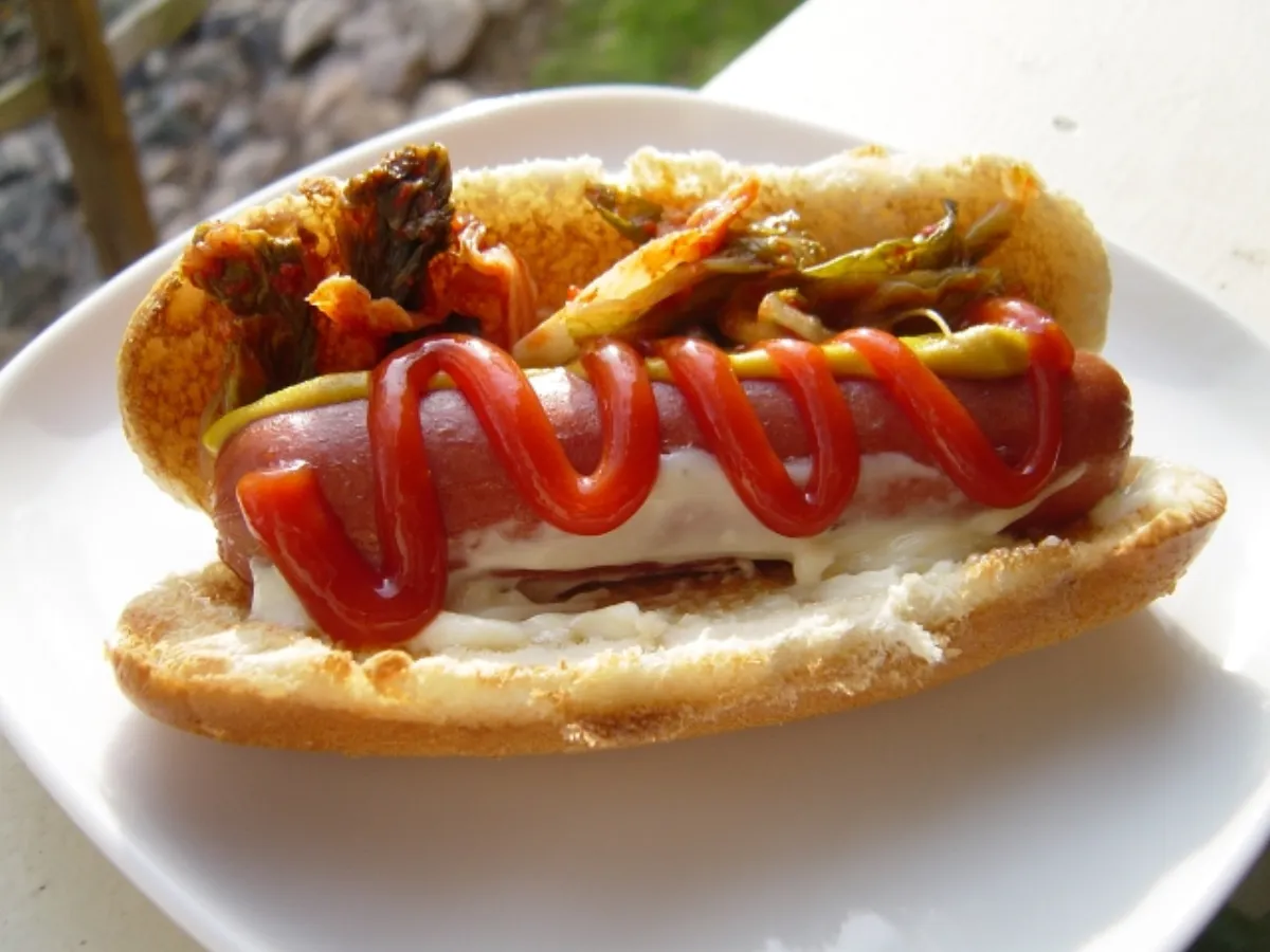 A classic hot dog dressed with ketchup and mustard — a combination loved everywhere except Chicago