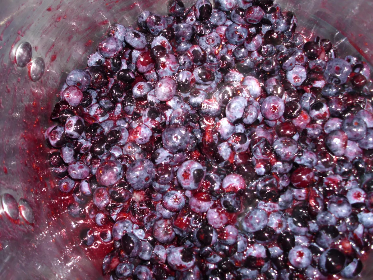 Blueberries bubbling away in a big pot of homemade jam