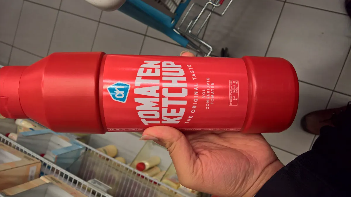 A bottle of tomato ketchup on the grocery store shelf