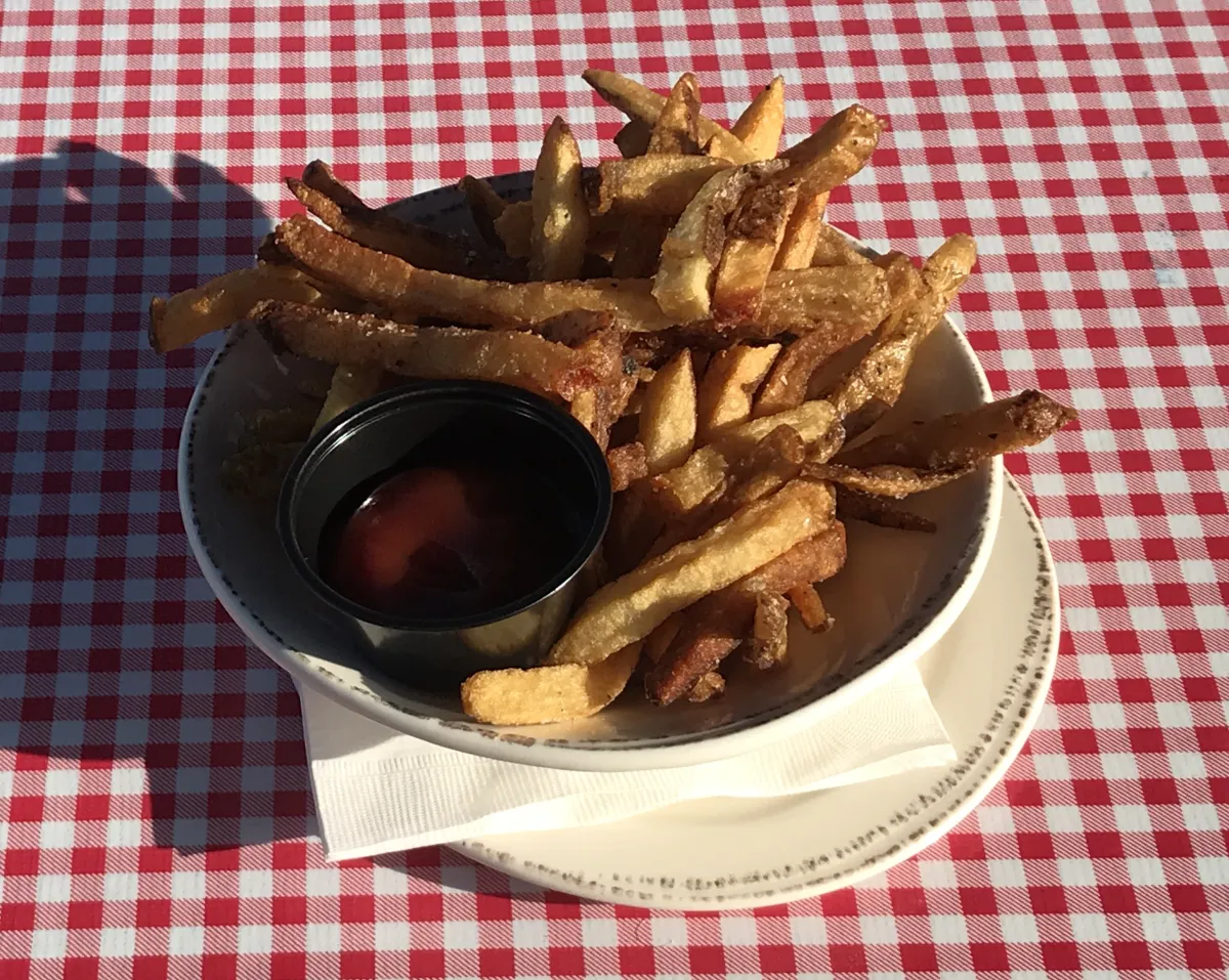 Golden fries served with a generous side of ketchup for dipping