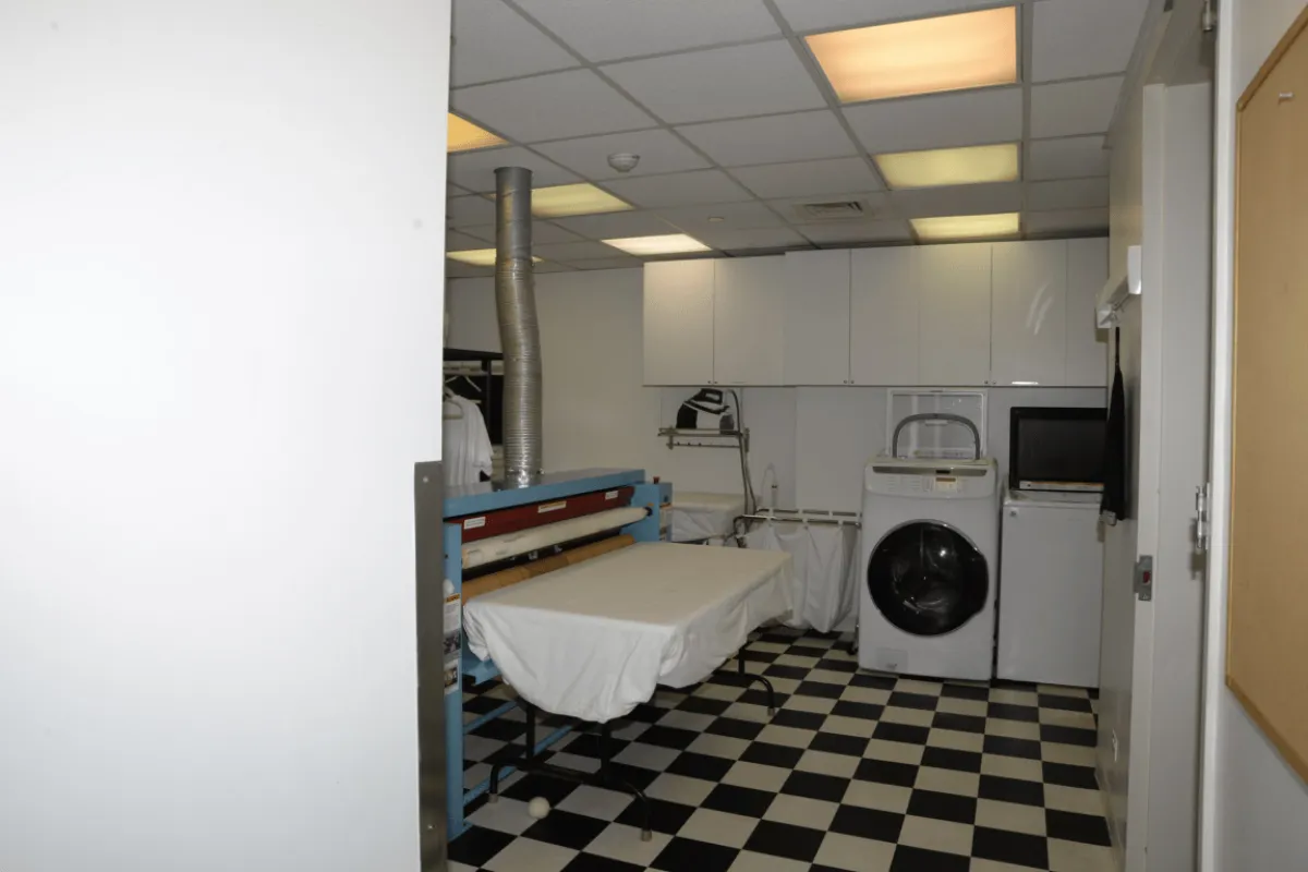 A clean laundry room with a washing machine ready for fabric care