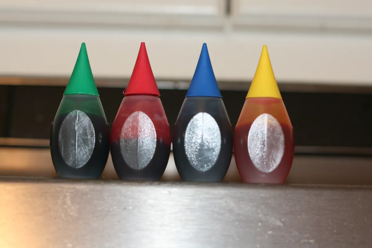 Colorful food coloring drops, reminiscent of novelty ketchup products
