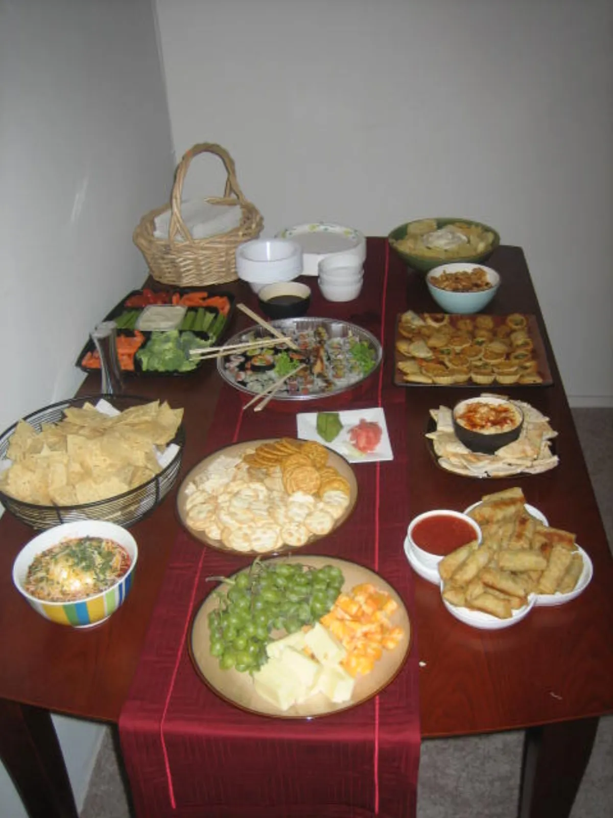 A colorful party buffet spread with dips and finger foods