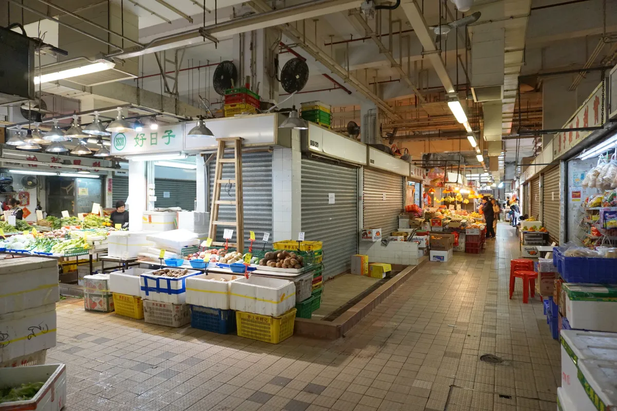 A bustling Southeast Asian market stall with exotic produce